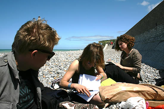 participants in conversation on the beach